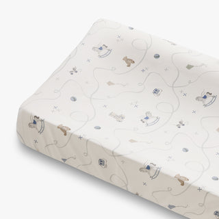 Baby changing pad with toy animal design on a white background