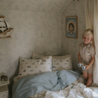 Transport Treasures Standard Pillowcase in Blue with little boy in bed. 