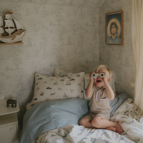 Transport Treasures Twin Set in Blue with child playing on bed