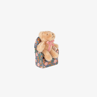 Small teddy bear with a floral-patterned box on a white background