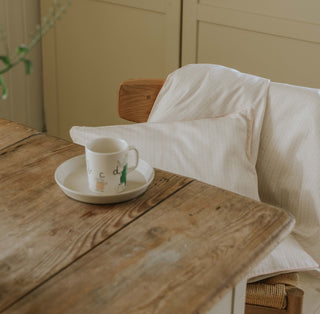 Petal Scallops Toddler Duvet and Pillow hanging over chair 
