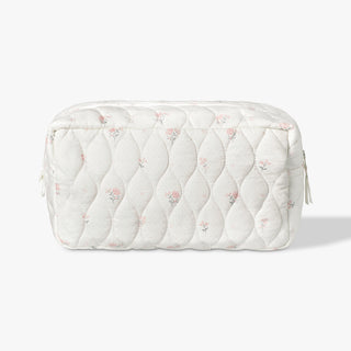 Quilted cosmetic bag with floral pattern on a white background