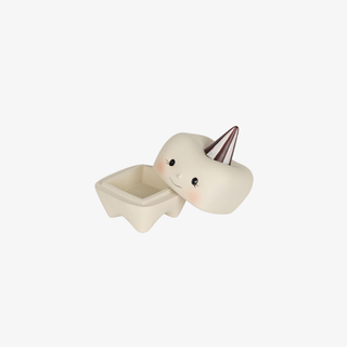 Small ceramic pot with a face and metallic horn on a white background