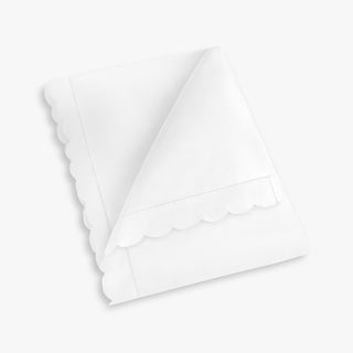 White baby duvet with scalloped edge with a plain background