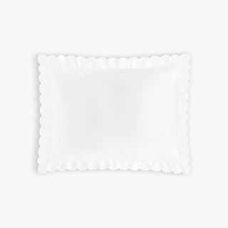 White scalloped edge pillow on a white background