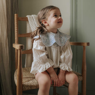 Winglet Bib- Enchanted Wildflower in Ivory on Toddler Girl
