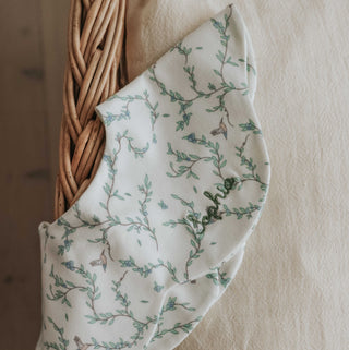 Winglet Bib in Secret Garden Ivory up close shot