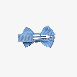 back of Blue bow hair clip on a light gray background