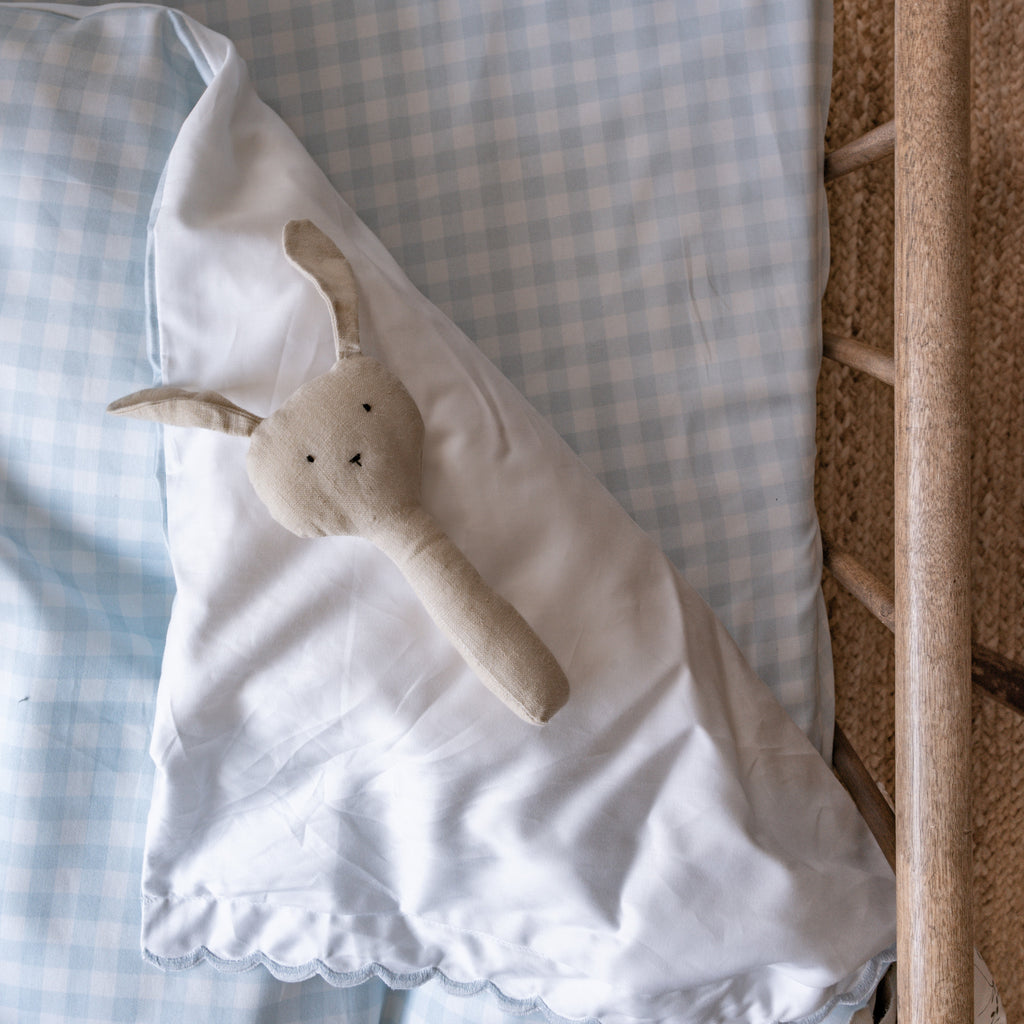 Up close blue gingham details in crib