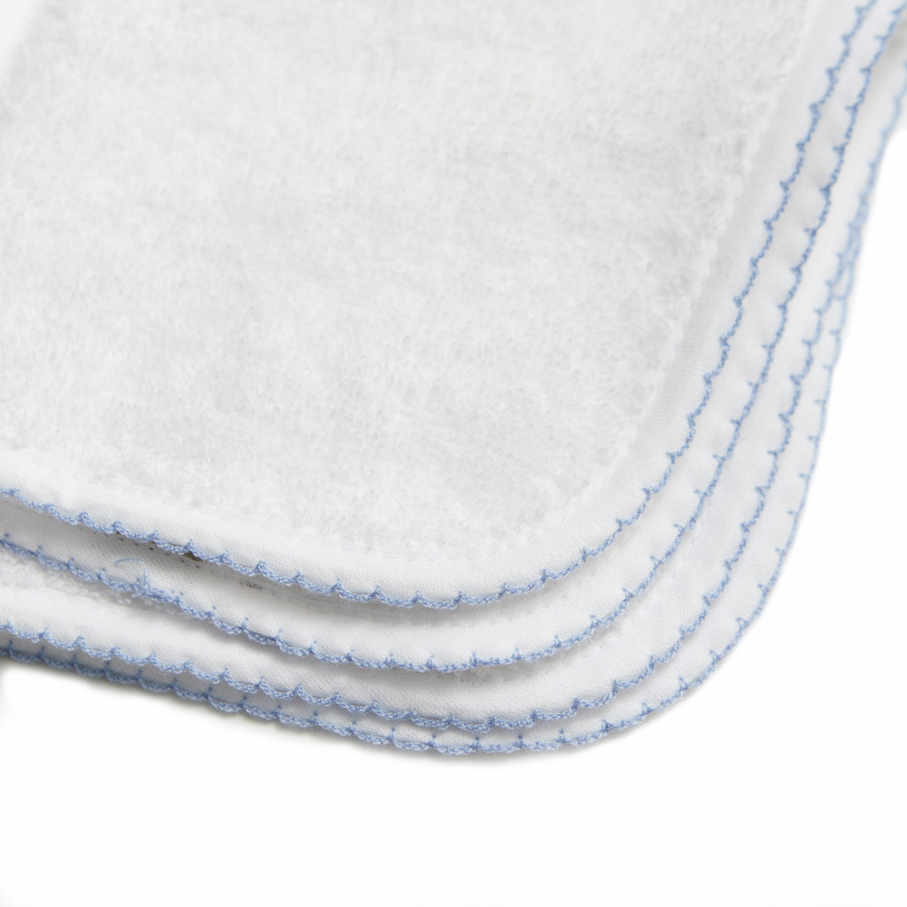 Classic Washcloth with Blue Trim Detail. Multiple are stacked on top of one another