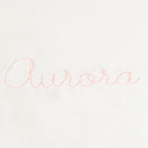 Monogram in pink color thread the name "Aurora"
