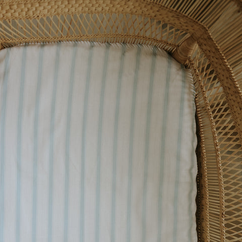 Blue Stripe Crib Sheet in a bassinet 