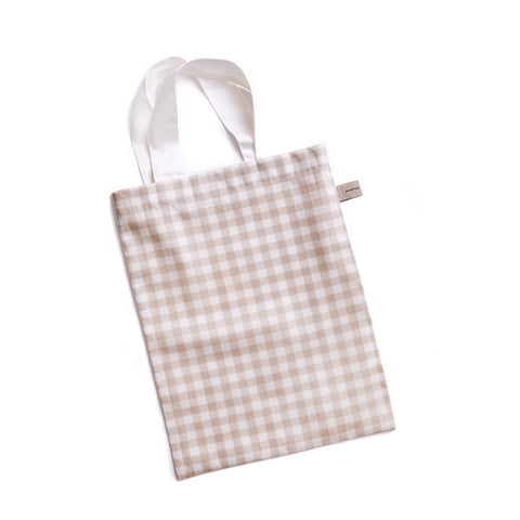 packaging of the bedding in the picnic gingham in beige
