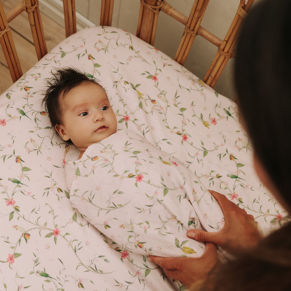 Dreaming of Paradise Swaddle with baby wrapped up inside with his mother