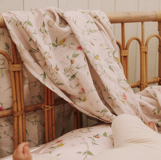 Dreaming of Paradise Swaddle hanging over crib