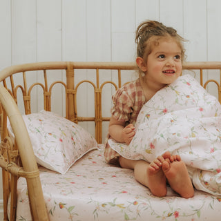 Dreaming of Paradise Toddler Duvet little girl sitting on bed cozy with Duvet