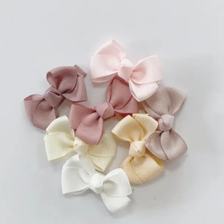 bows of neutral pink and white on a white background