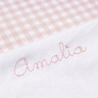 Embroidered name 'Amalia' on a pink and white checkered fabric background