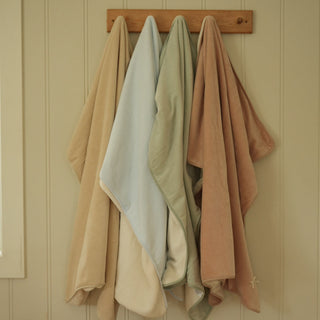 four blankets hanging on the wall 