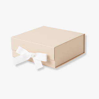 Beige gift box with a white ribbon on a light beige background