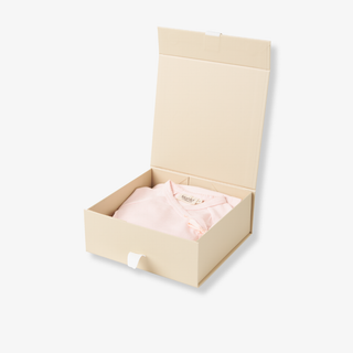 Beige box with a pink garment inside on a white background