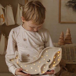 boy holding Little Lights Whale Lamp