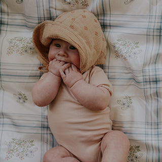Baby laying on the Baby Duvet in the Fleur and Stripe Print in Multi Color