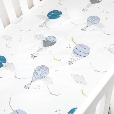 Crib Sheet in "Touch The Sky" print in the color blue featured in a crib