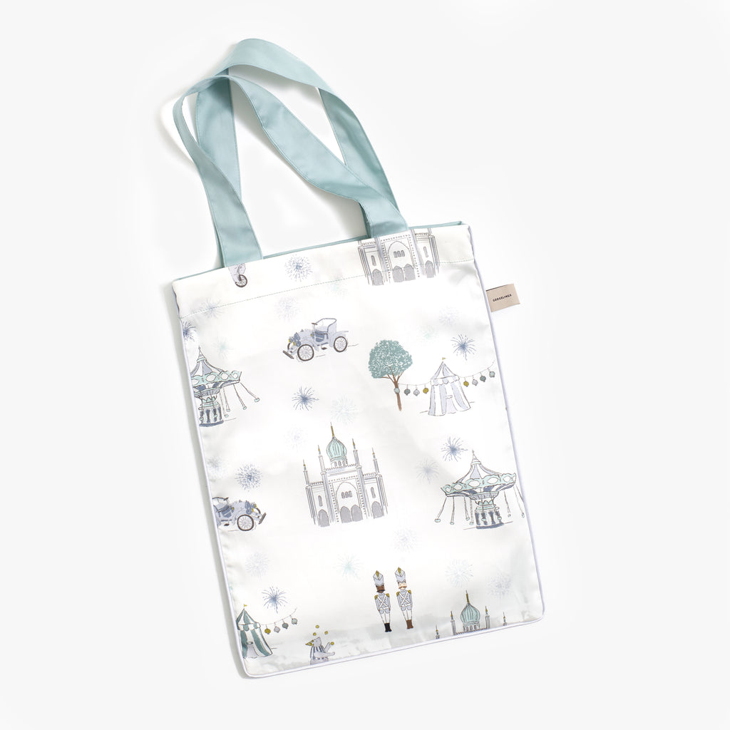 Printed tote bag is included with toddler duvet in "Adventures in Wonderland" print in the color aqua