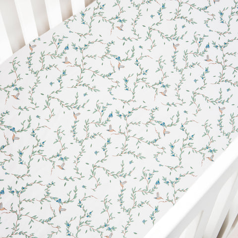 Crib Sheet in the "Secret Garden" print in the color ivory featured in a crib