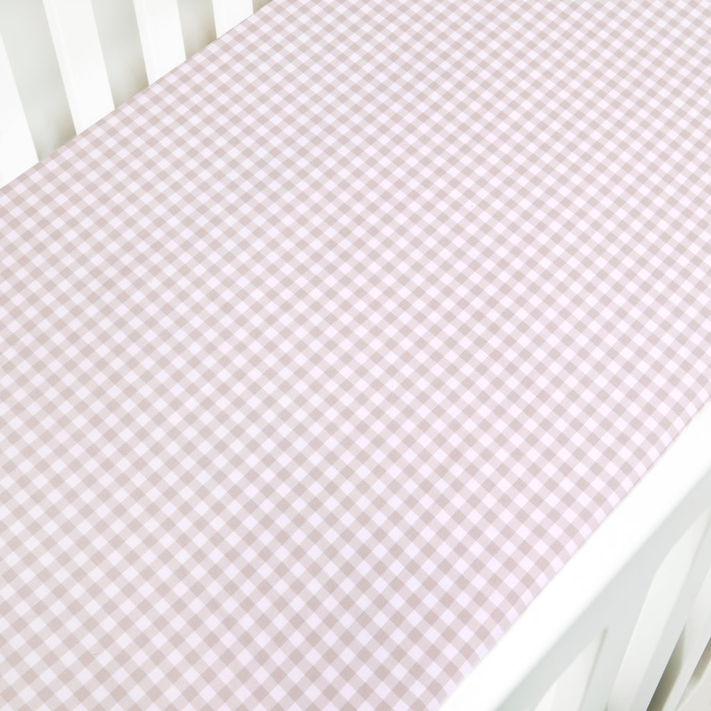Crib Sheet in Picnic Gingham Print in Beige Color laid on a crib