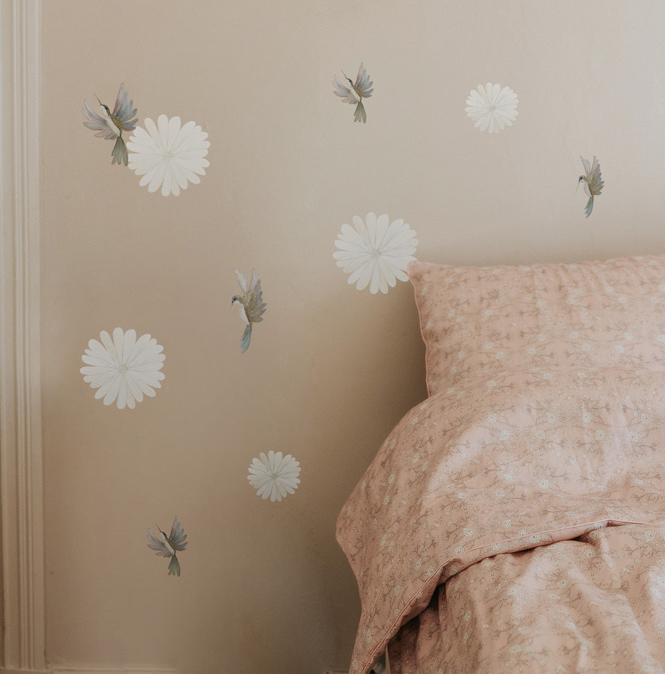 Bird and FLower decals on a wall with bed next to it