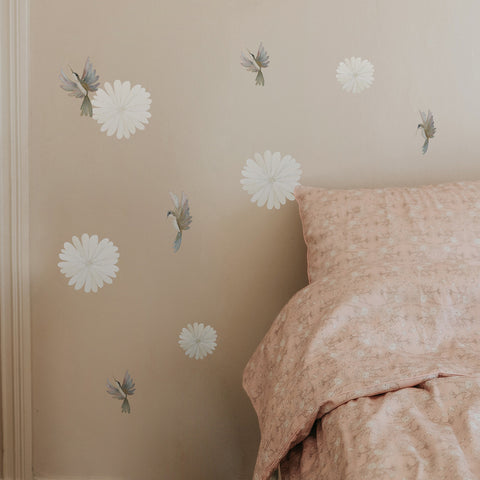 Bird and FLower decals on a wall with bed next to it