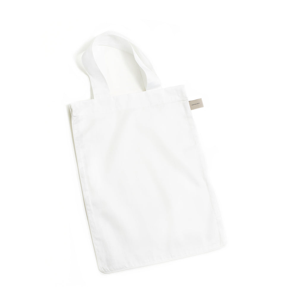 Solid tote bag is included with crib sheet in the color white