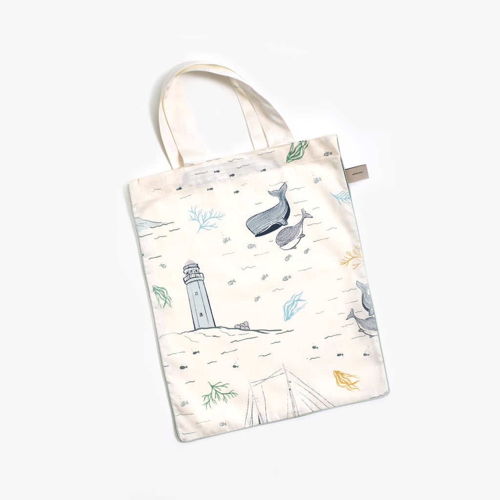 Printed tote bag is included with the bedding set in the "Never Stop Exploring" print in the color ivory