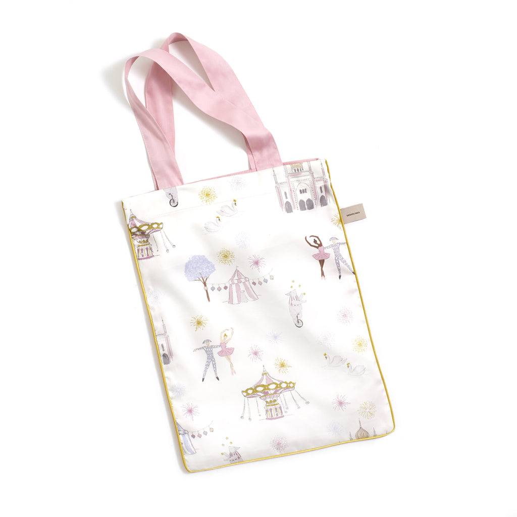 Printed tote bag is included with crib sheet in "Adventures in Wonderland" print in the color rose