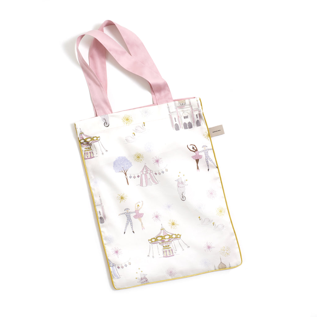 Printed tote bag is included with crib sheet in "Adventures in Wonderland" print in the color rose