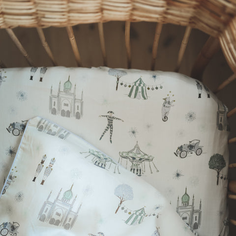 "Adventures in Wonderland" print in the color aqua featured in a crib 