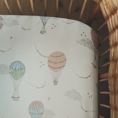 Crib Sheet in "Touch The Sky" print in the color pink featured in a crib