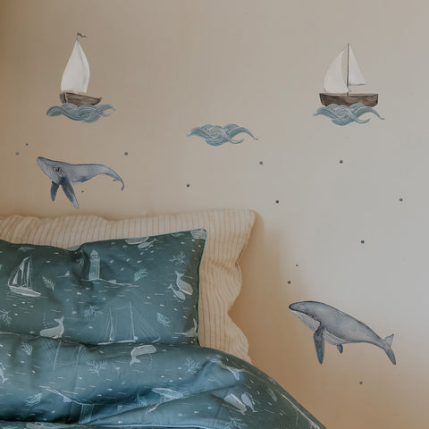 Wall decals featuring boats and sea animals, with bubbles