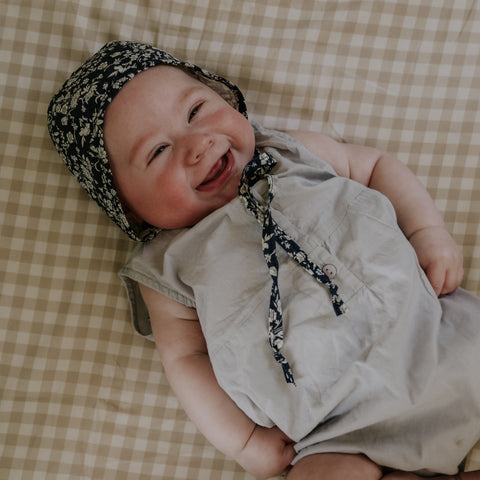 Baby Laying on top of Baby Duvet in the Picnic Gingham Print in Beige